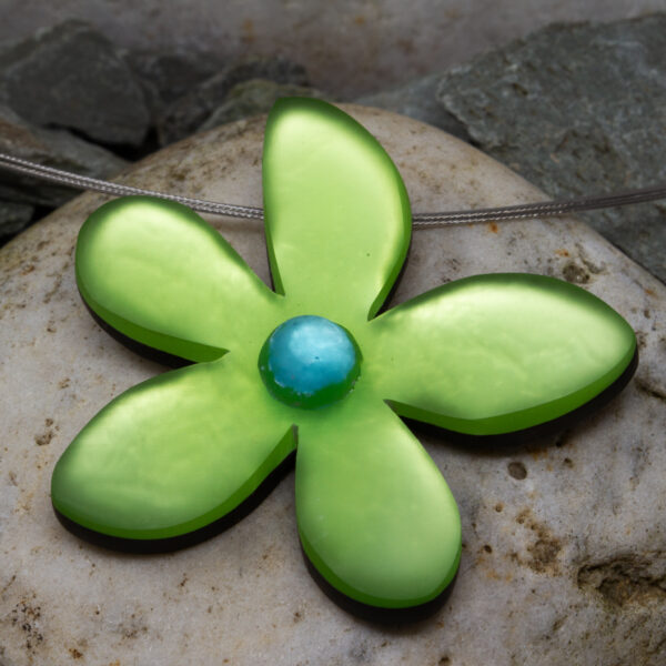 a hand crafted flower pendant