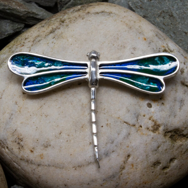 an enamelled dragonfly brooch
