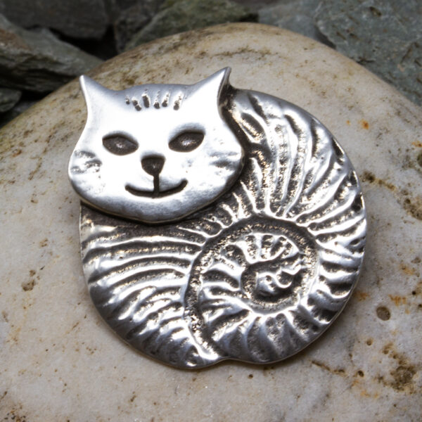 a fat cat brooch made of pewter