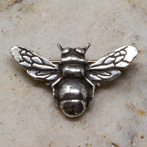 a small bee brooch made from pewter