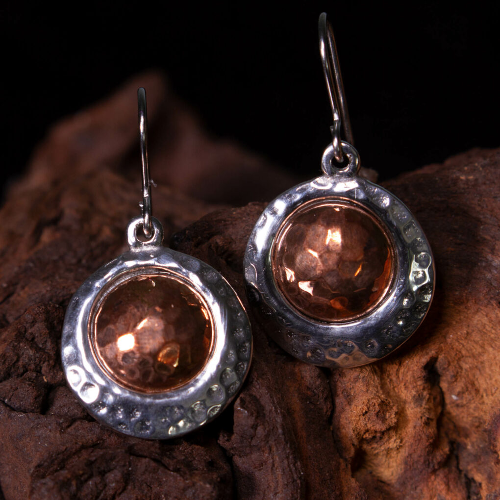 a pair of copper offset earrings