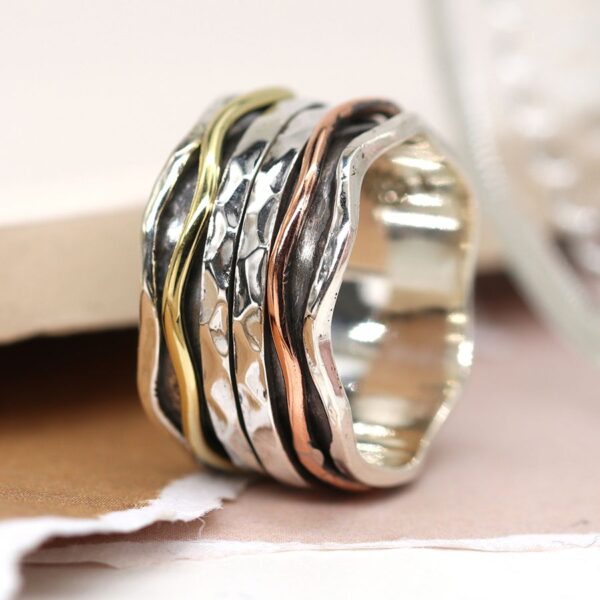 Sterling silver wave edge spinning ring with hammered moving silver bands and copper & brass wave band